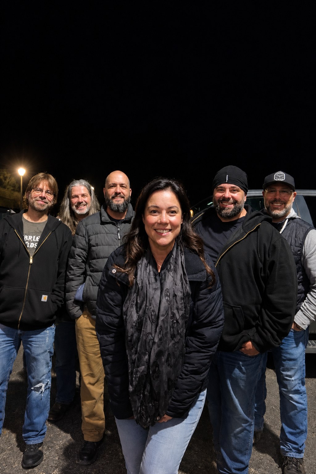 Lights Out band members posing together outdoors at night